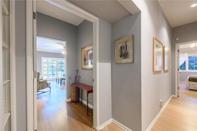 hallway with light hardwood / wood-style flooring