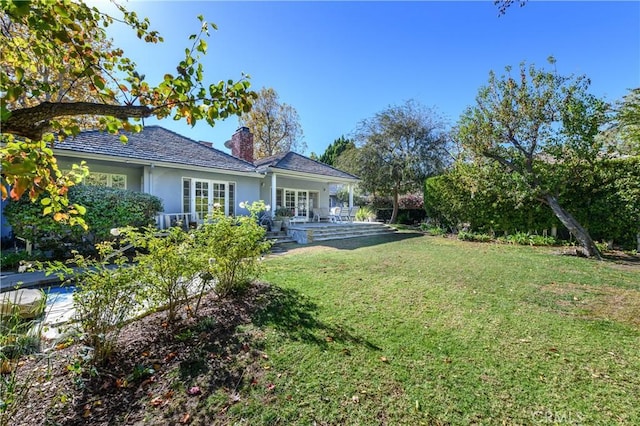 view of yard featuring french doors