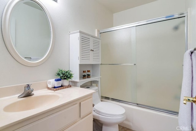 full bathroom with vanity, enclosed tub / shower combo, and toilet