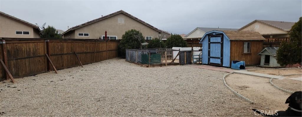 view of yard with a storage shed and a pool