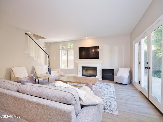 living room with light hardwood / wood-style floors and french doors