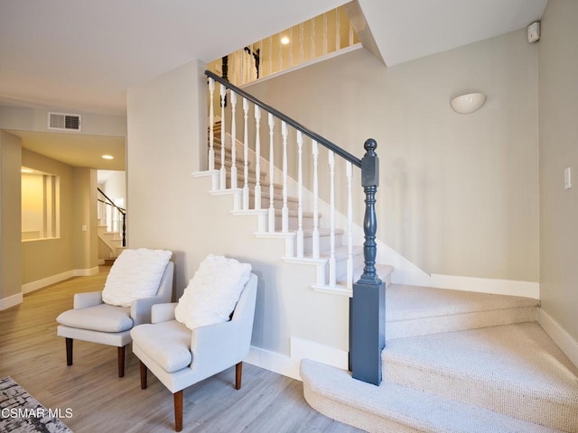 stairs with hardwood / wood-style flooring