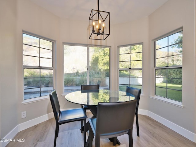 dining space featuring an inviting chandelier and light hardwood / wood-style flooring