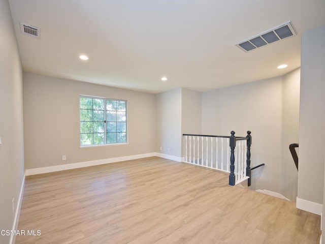 empty room with light hardwood / wood-style flooring