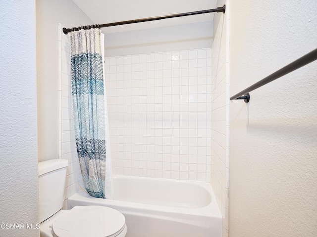 bathroom with shower / bath combination with curtain and toilet