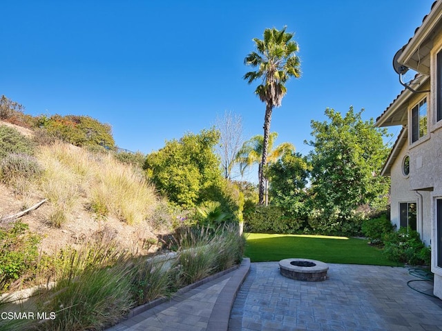 view of patio / terrace featuring an outdoor fire pit