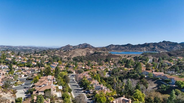 birds eye view of property featuring a water and mountain view