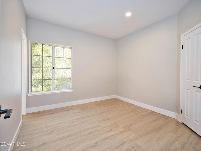 spare room featuring light wood-type flooring