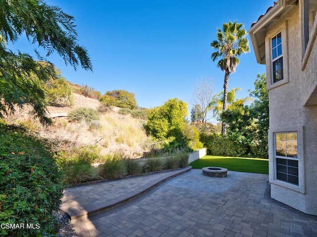 view of patio / terrace with a fire pit