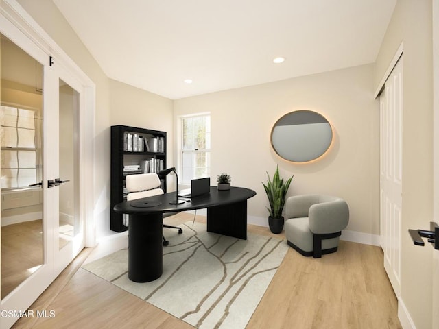 home office featuring french doors and light hardwood / wood-style floors