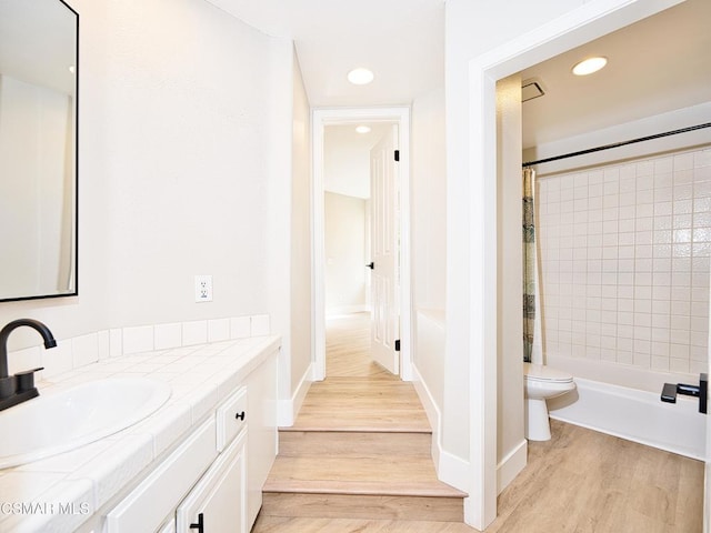 full bathroom with shower / tub combo, vanity, toilet, and hardwood / wood-style floors