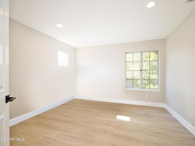 empty room with light hardwood / wood-style floors