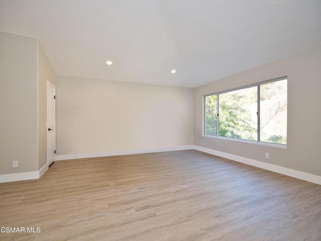 spare room featuring light hardwood / wood-style floors