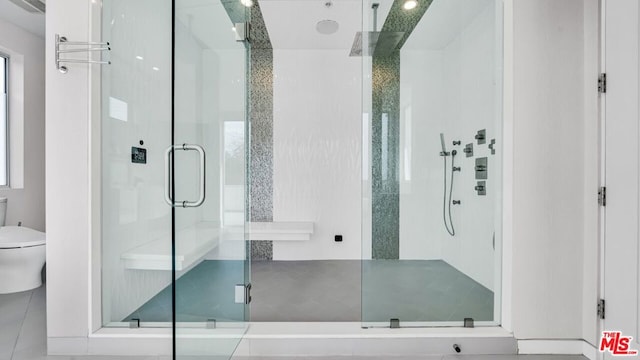 bathroom with an enclosed shower and toilet