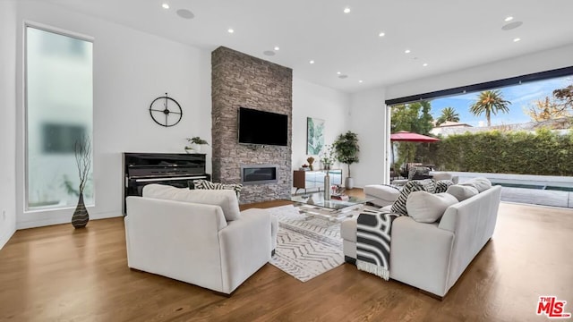 living room with hardwood / wood-style flooring and a fireplace