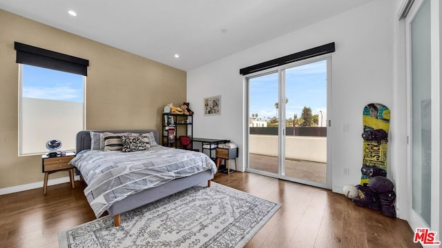 bedroom with hardwood / wood-style flooring and access to exterior