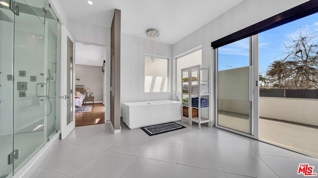 bathroom featuring shower with separate bathtub, tile patterned flooring, and a wealth of natural light