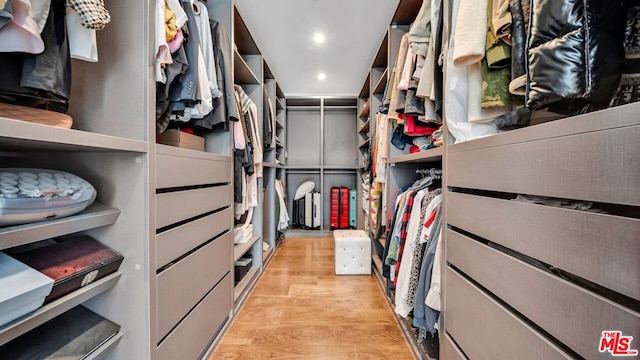 walk in closet featuring light hardwood / wood-style flooring