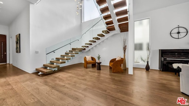 foyer featuring hardwood / wood-style flooring and a towering ceiling