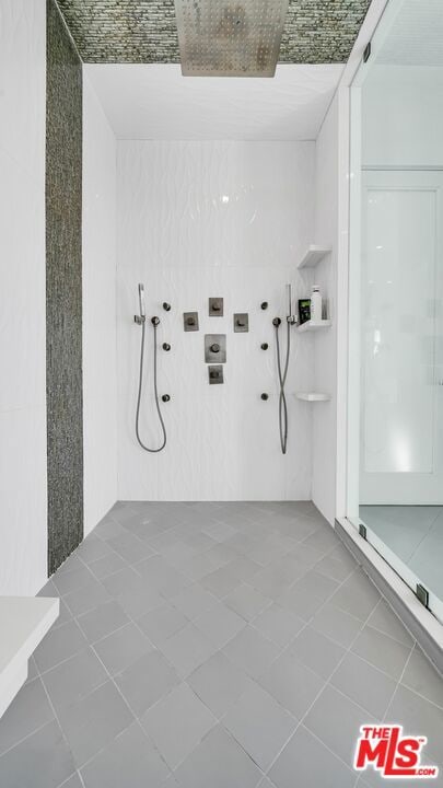 bathroom featuring tile patterned floors and a shower