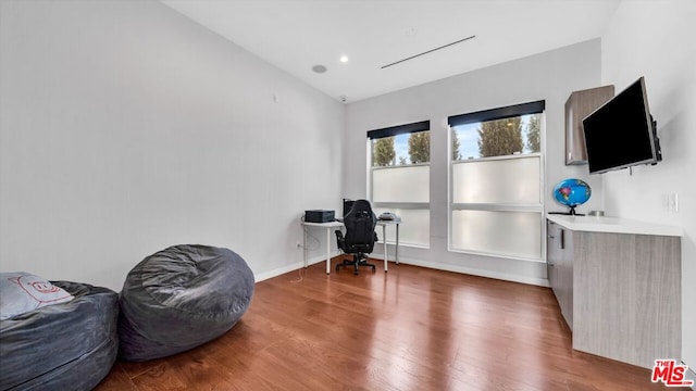 office featuring hardwood / wood-style flooring and vaulted ceiling