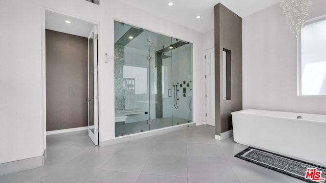 bathroom featuring tile patterned floors and independent shower and bath