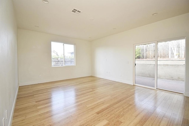 unfurnished room with light wood-type flooring