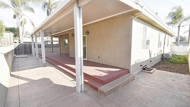 view of patio / terrace featuring cooling unit and a wooden deck