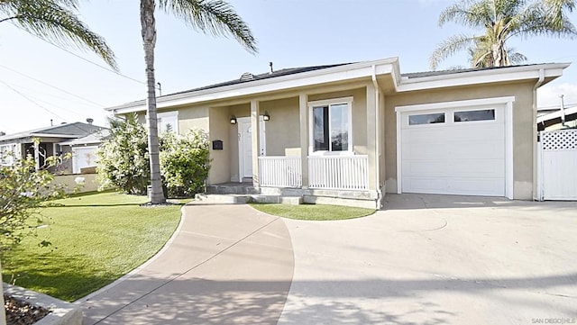 view of front of property with a porch, a garage, and a front yard