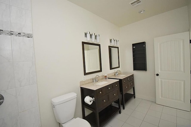 bathroom featuring vanity, tile patterned floors, and toilet