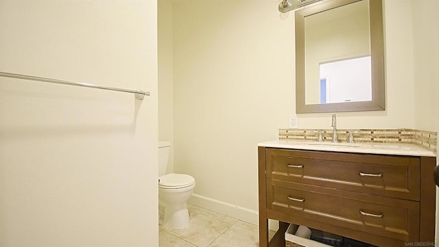 bathroom featuring tile patterned flooring, vanity, and toilet