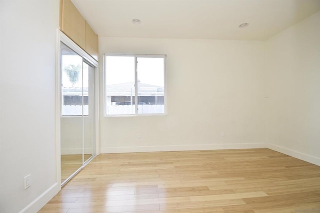 spare room with light wood-type flooring