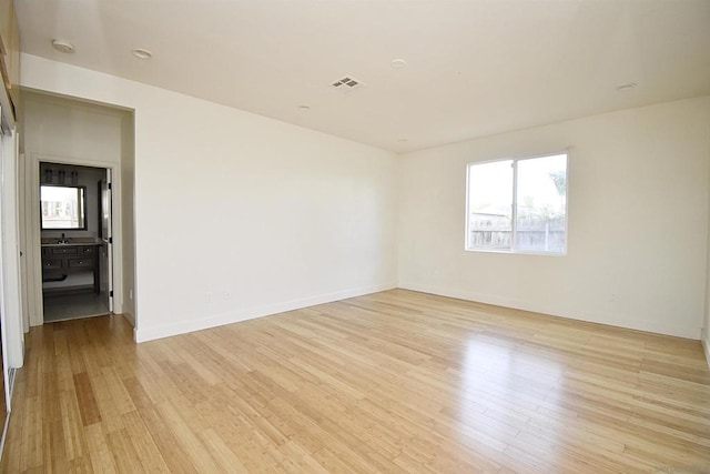 unfurnished room with light wood-type flooring