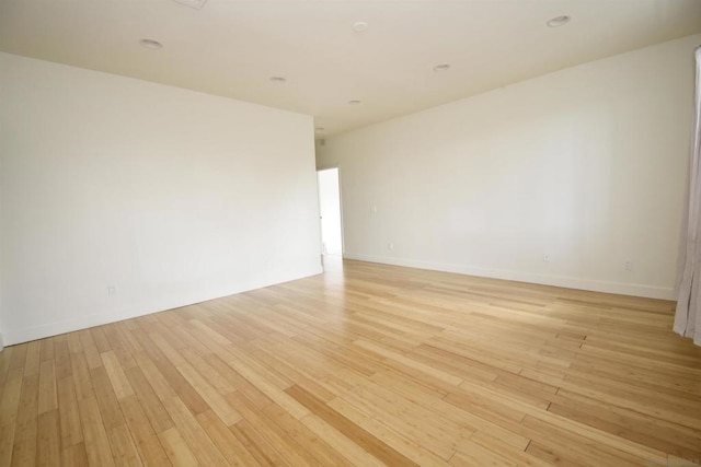 empty room with light hardwood / wood-style floors