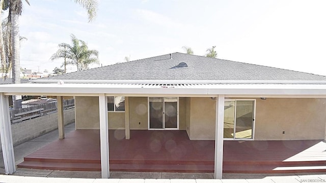 rear view of property featuring a deck