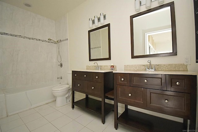 full bathroom featuring vanity, tile patterned flooring, toilet, and tiled shower / bath