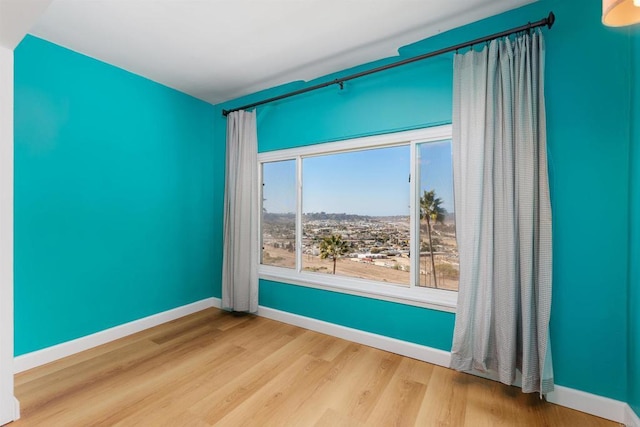 unfurnished room with hardwood / wood-style flooring