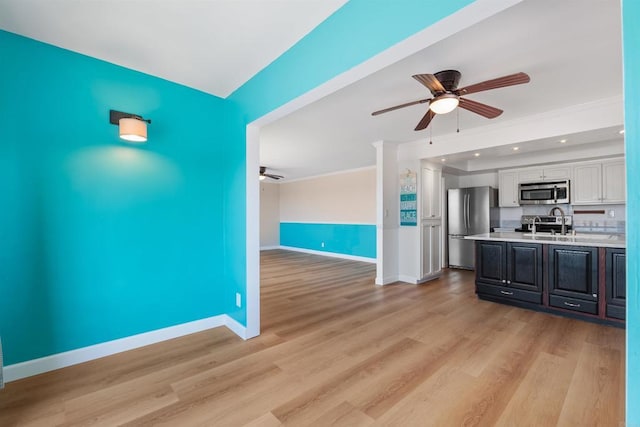 interior space with crown molding, ceiling fan, and light wood-type flooring