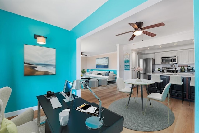 dining area featuring ceiling fan, ornamental molding, and light hardwood / wood-style flooring