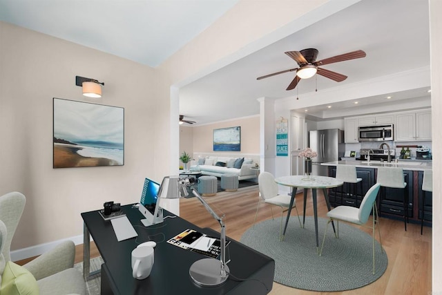 interior space with light wood-style flooring, baseboards, a ceiling fan, and recessed lighting