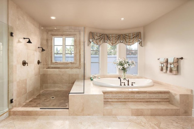 bathroom featuring separate shower and tub and a healthy amount of sunlight