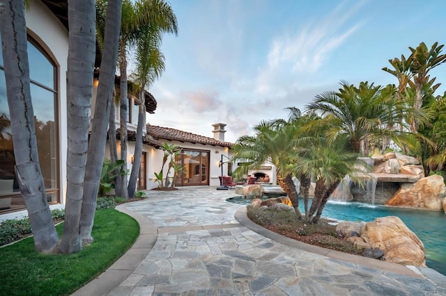 view of home's community with a swimming pool and a patio