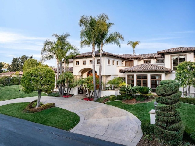 mediterranean / spanish house with a front lawn