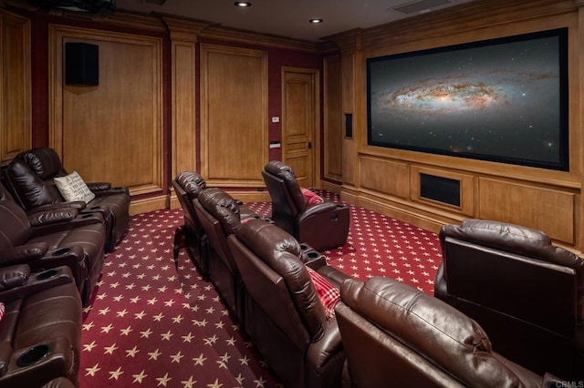 carpeted cinema room featuring ornamental molding