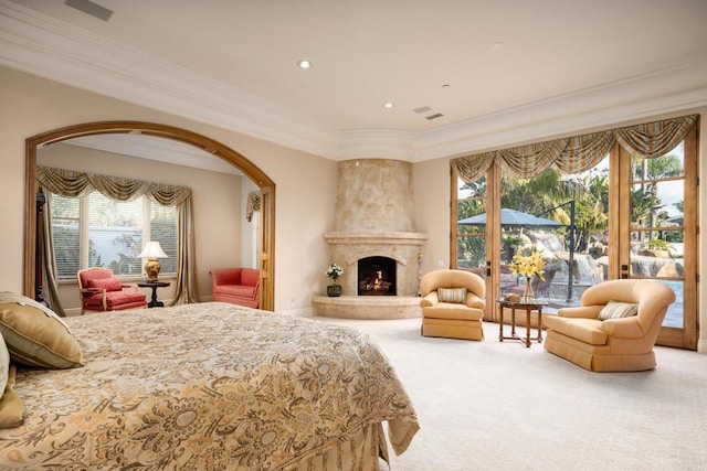 bedroom featuring access to exterior, crown molding, a fireplace, and carpet flooring