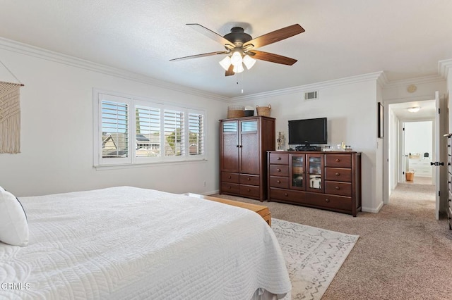 carpeted bedroom with ornamental molding and ceiling fan