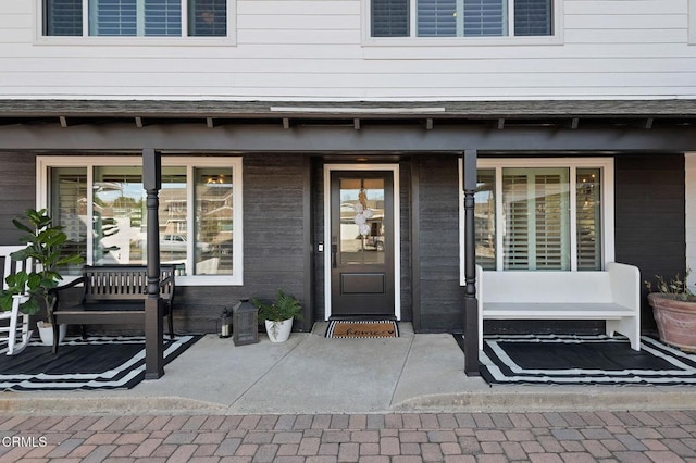 doorway to property featuring covered porch