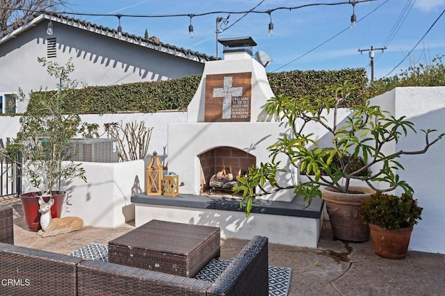 view of patio / terrace featuring an outdoor fireplace