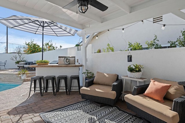 view of patio with a bar and area for grilling