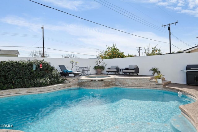 view of swimming pool with grilling area and an in ground hot tub